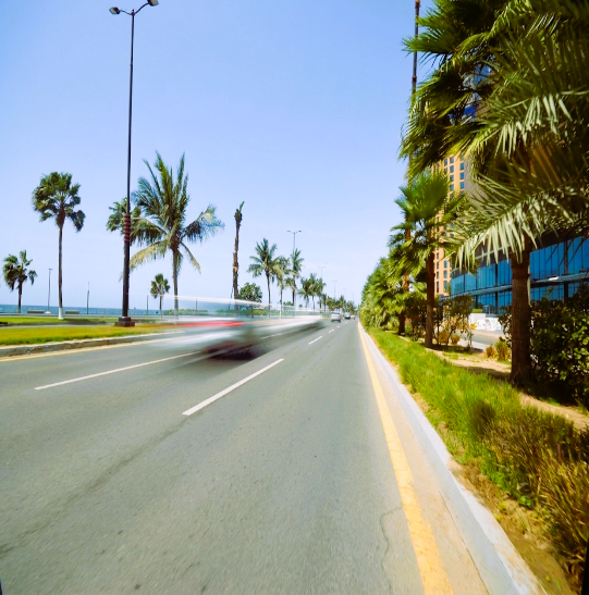 Maintained urban road with lighting landscaping and directional infrastructure